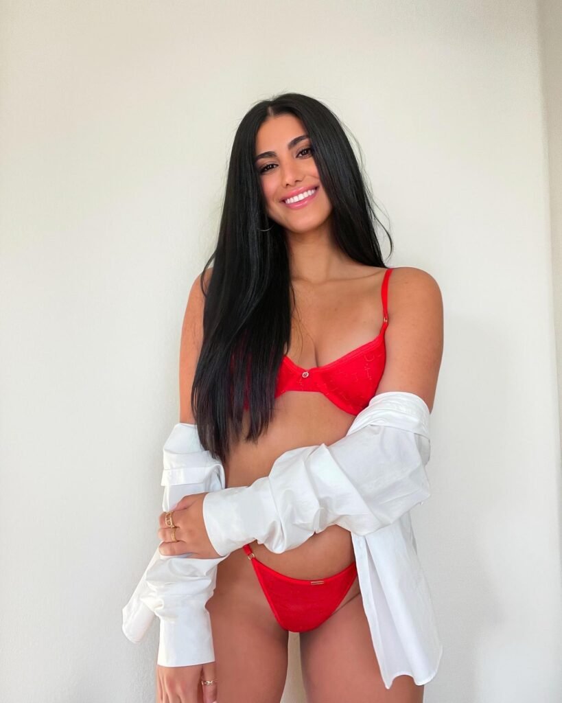 persian model with long dark hair wearing a gray tailored blazer looking into camera with a professional look