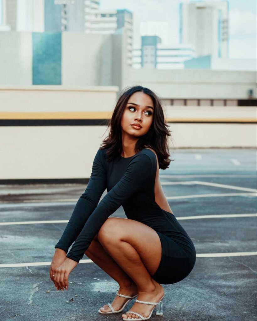 persian model with long dark hair wearing a charcoal gray tailored blazer looking professional
