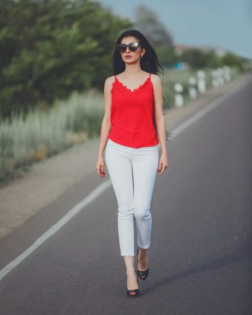 persian model with long dark hair looking into camera wearing a grey tank top
