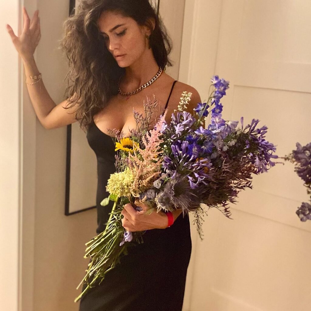 persian model with long dark hair wearing a black leather biker jacket with a bold expression